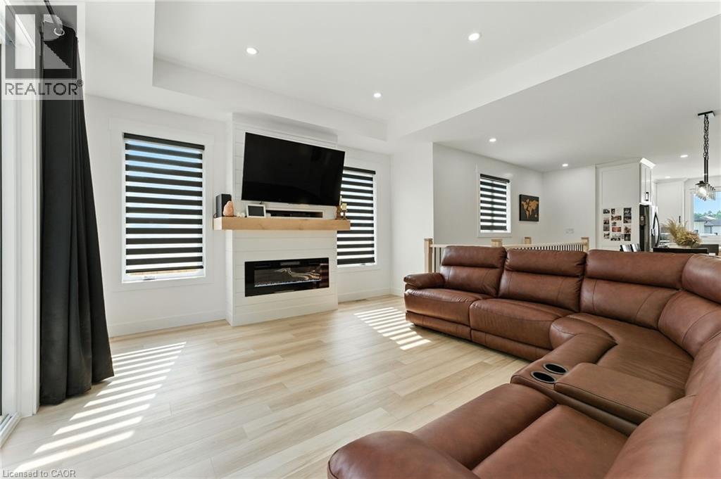 Living area featuring recessed lighting, light wood-style floors, and a fireplace - 9 Macneil Court, Port Burwell, ON - Indoor Photo Showing Living Room With Fireplace