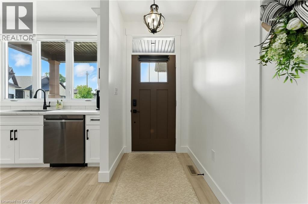 Entrance foyer featuring light wood-type flooring and a chandelier - 9 Macneil Court, Port Burwell, ON - Indoor