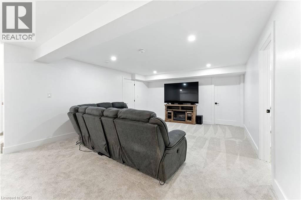 Living area featuring light colored carpet and recessed lighting - 9 Macneil Court, Port Burwell, ON - Indoor