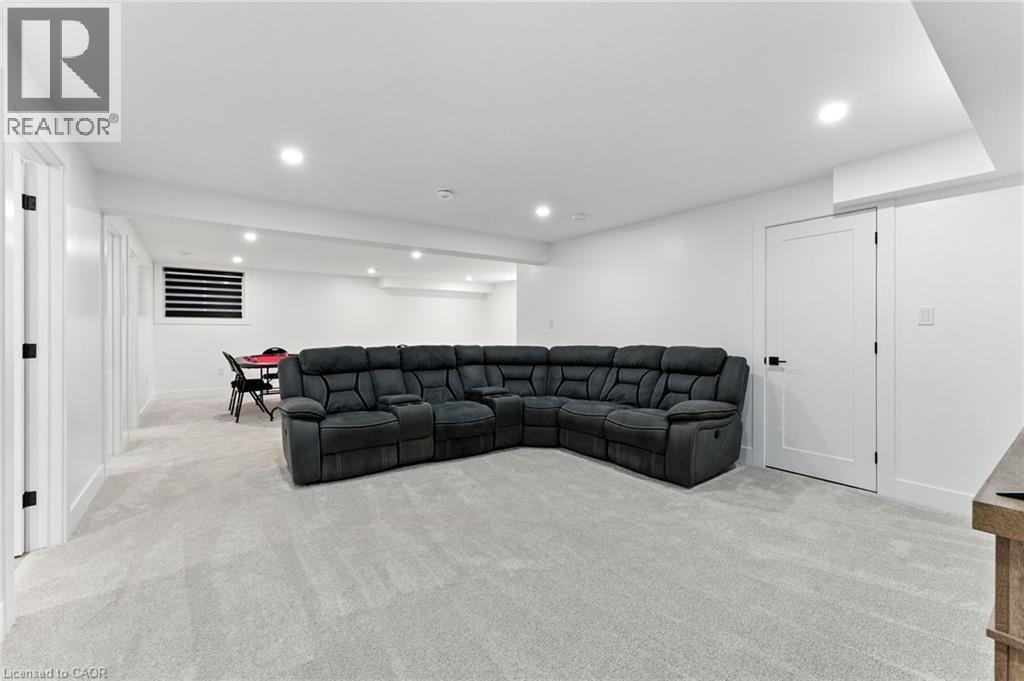 Living room with light carpet and recessed lighting - 9 Macneil Court, Port Burwell, ON - Indoor