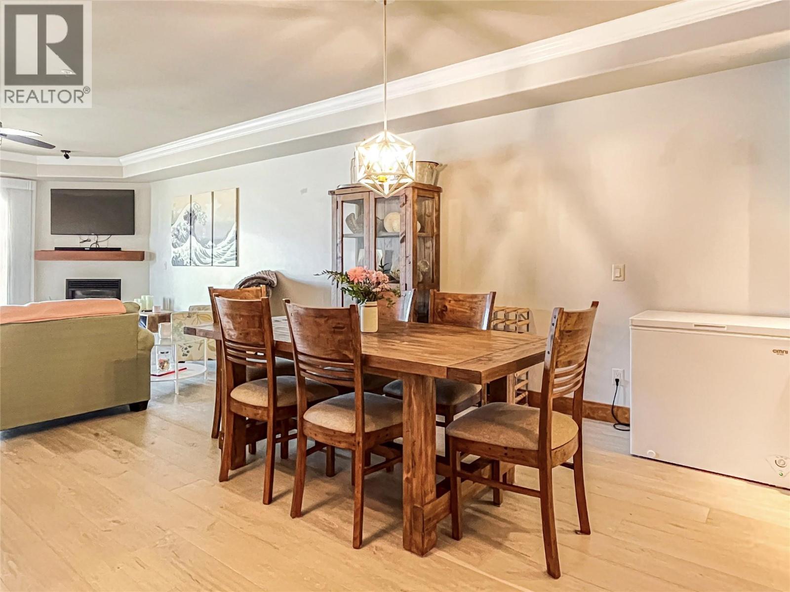 2418 Lakeshore Drive Unit# 302, Osoyoos, BC - Indoor Photo Showing Dining Room With Fireplace