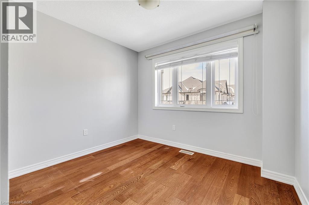 Spare room with baseboards and wood finished floors - 89 Sonoma Valley Crescent, Hamilton, ON - Indoor Photo Showing Other Room