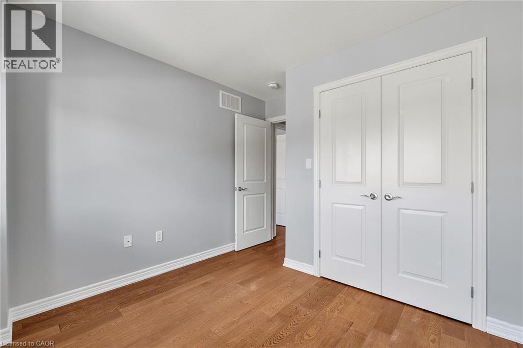 Unfurnished bedroom featuring wood finished floors and a closet - 89 Sonoma Valley Crescent, Hamilton, ON - Indoor Photo Showing Other Room