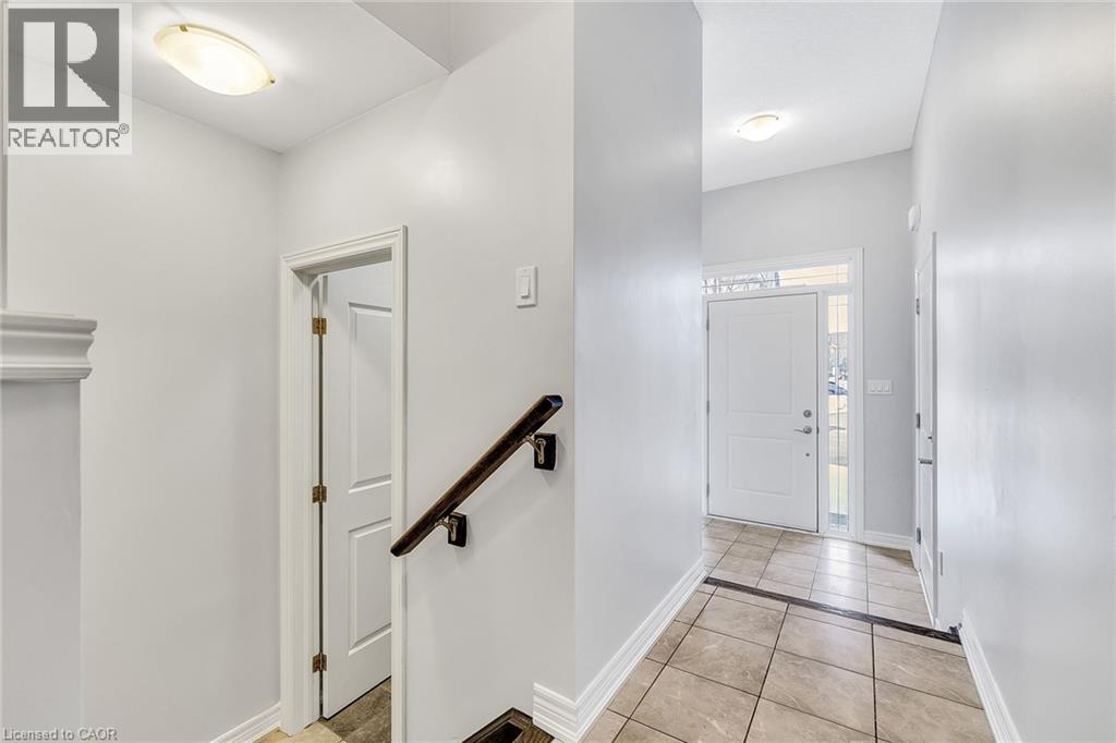 Entrance foyer featuring light tile patterned flooring and baseboards - 89 Sonoma Valley Crescent, Hamilton, ON - Indoor Photo Showing Other Room