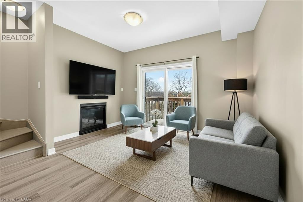 Virtually Staged Living Room With F/P & Walk Out - 48 Markle Crescent, Ancaster, ON - Indoor Photo Showing Living Room With Fireplace