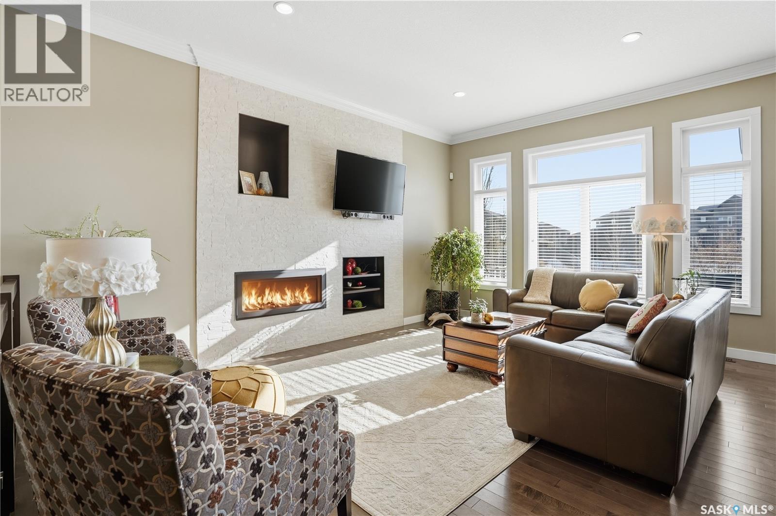 4506 Sandpiper Crescent E, Regina, SK - Indoor Photo Showing Living Room With Fireplace