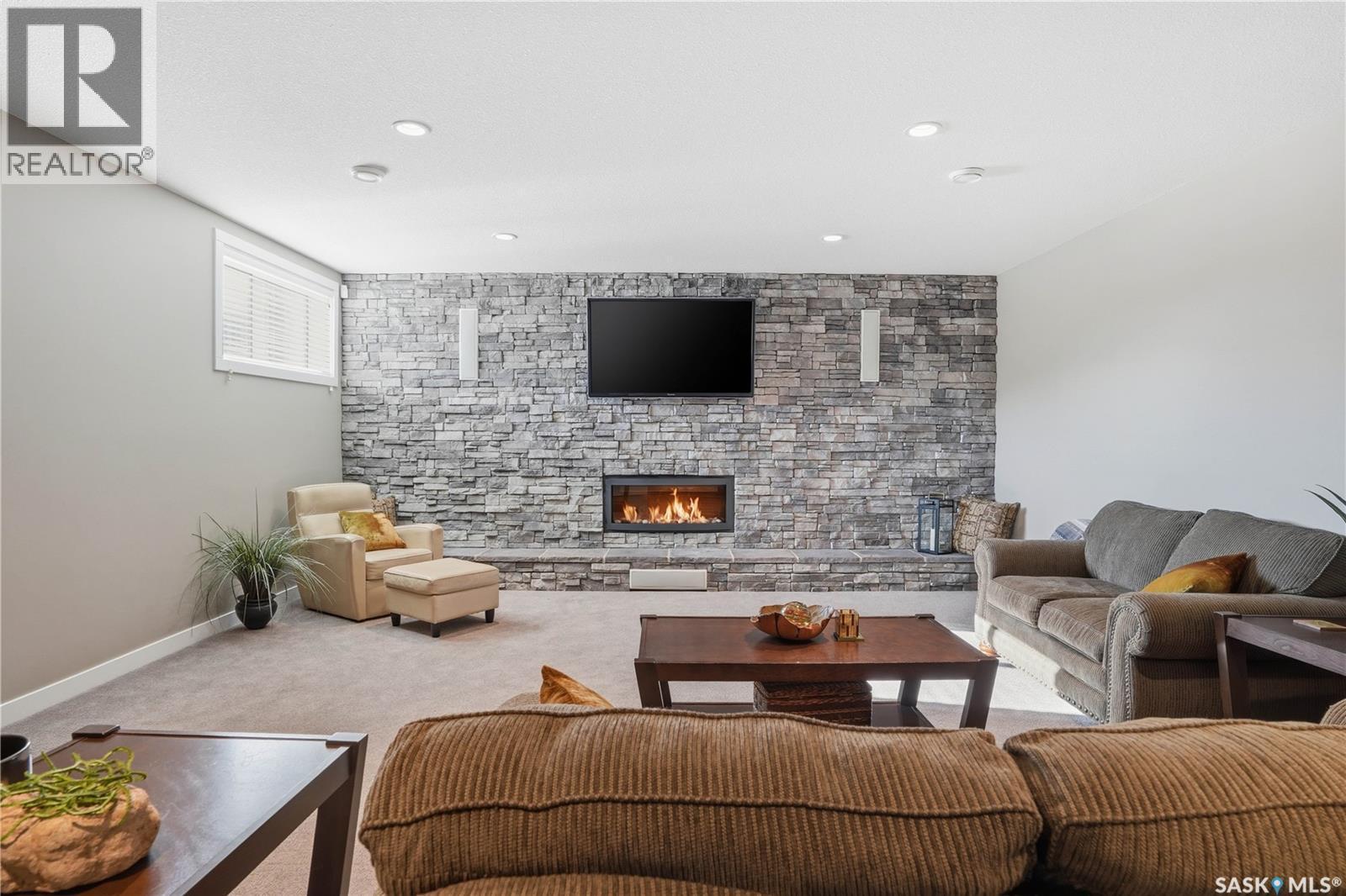 4506 Sandpiper Crescent E, Regina, SK - Indoor Photo Showing Living Room With Fireplace