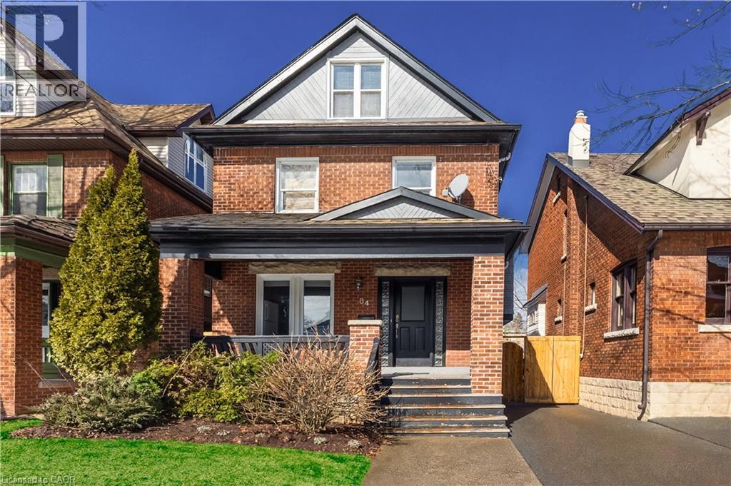 View of front of home with brick siding and covered porch - 84 South Oval, Hamilton, ON - Outdoor