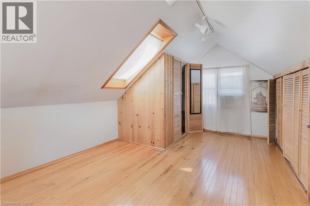 Bonus room with a skylight, light wood-style flooring, and lofted ceiling - 84 South Oval, Hamilton, ON - Indoor Photo Showing Other Room