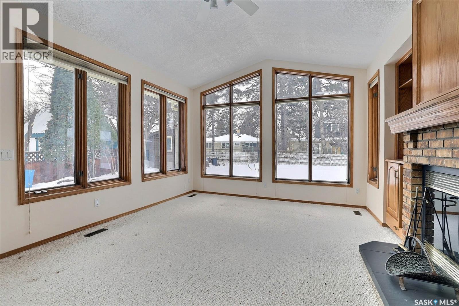14 Deergrove Crescent, Regina, SK - Indoor Photo Showing Other Room With Fireplace