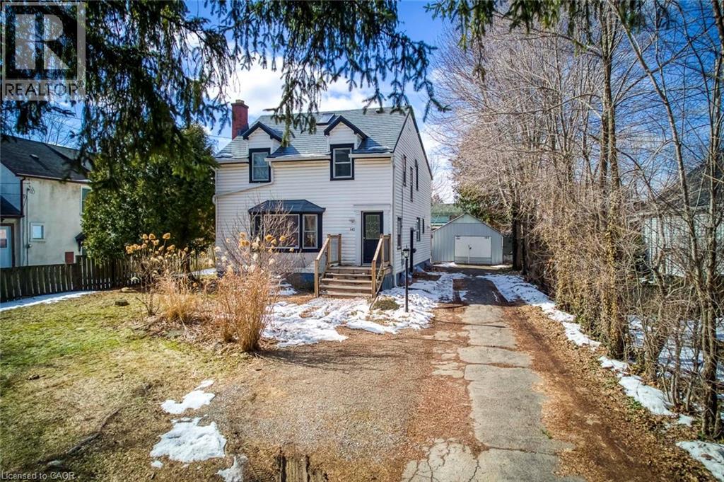 Traditional home with a chimney, an outbuilding, a garage, and driveway - 142 Ewen Road, Hamilton, ON - Outdoor