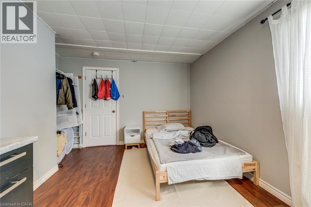 Bedroom with dark wood-type flooring and a closet - 142 Ewen Road, Hamilton, ON - Indoor Photo Showing Bedroom