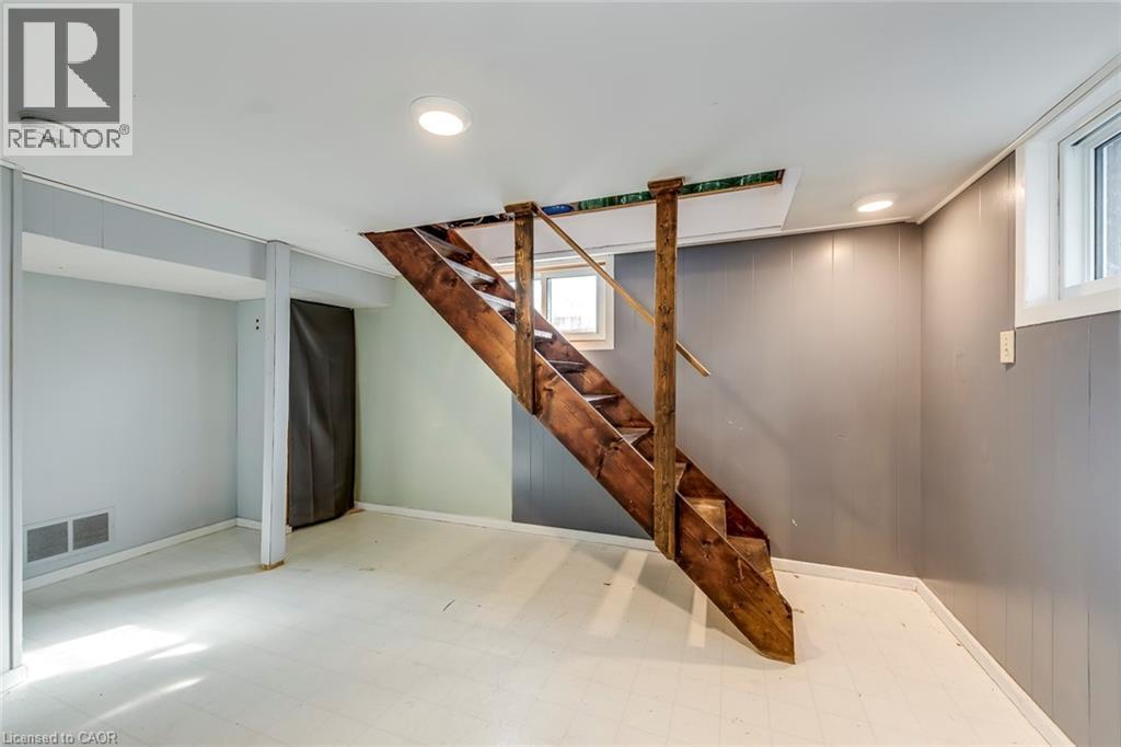 Below grade area with light floors, wooden walls, and recessed lighting - 142 Ewen Road, Hamilton, ON - Indoor Photo Showing Other Room