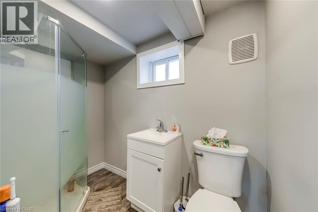 Full bath with a stall shower, vanity, and dark wood finished floors - 142 Ewen Road, Hamilton, ON - Indoor Photo Showing Bathroom