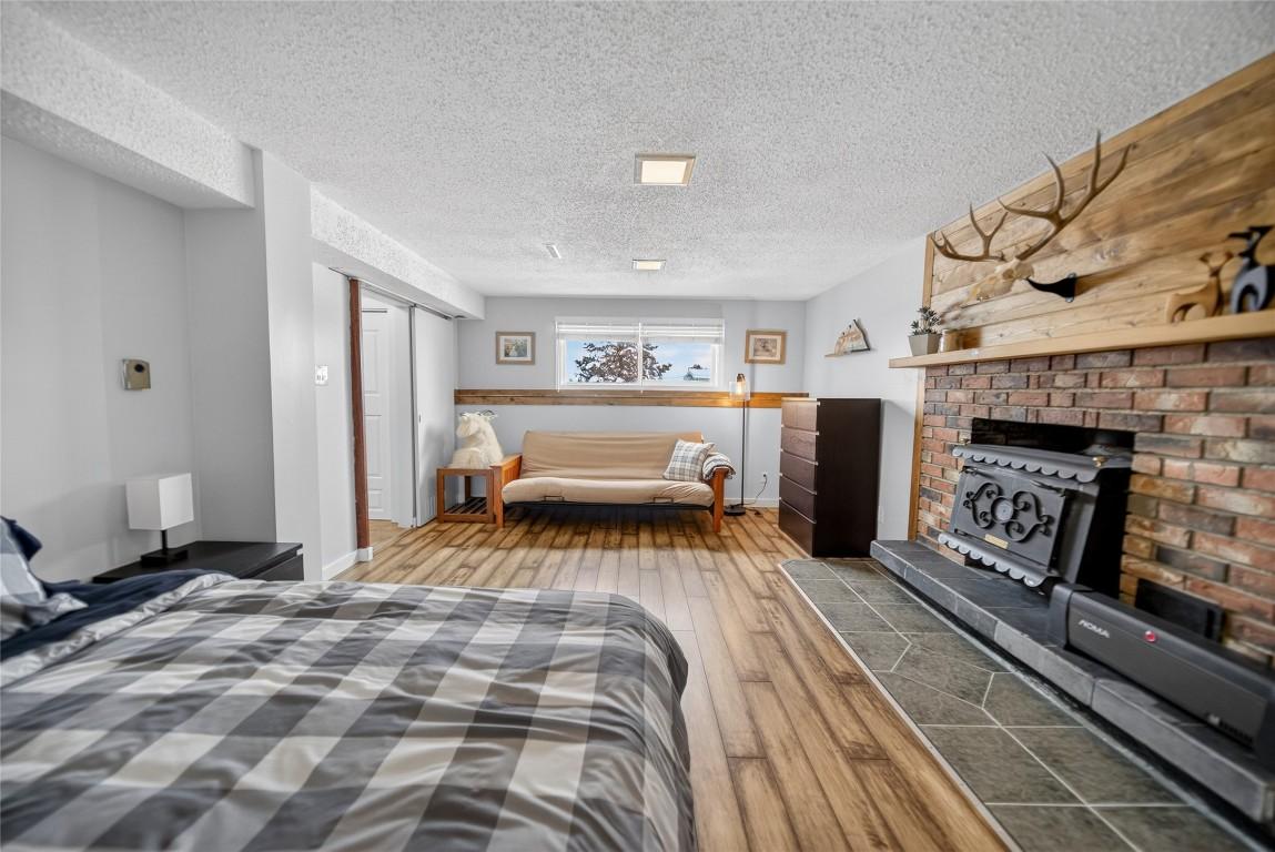 209 14Th Street, Cranbrook, BC - Indoor Photo Showing Bedroom With Fireplace