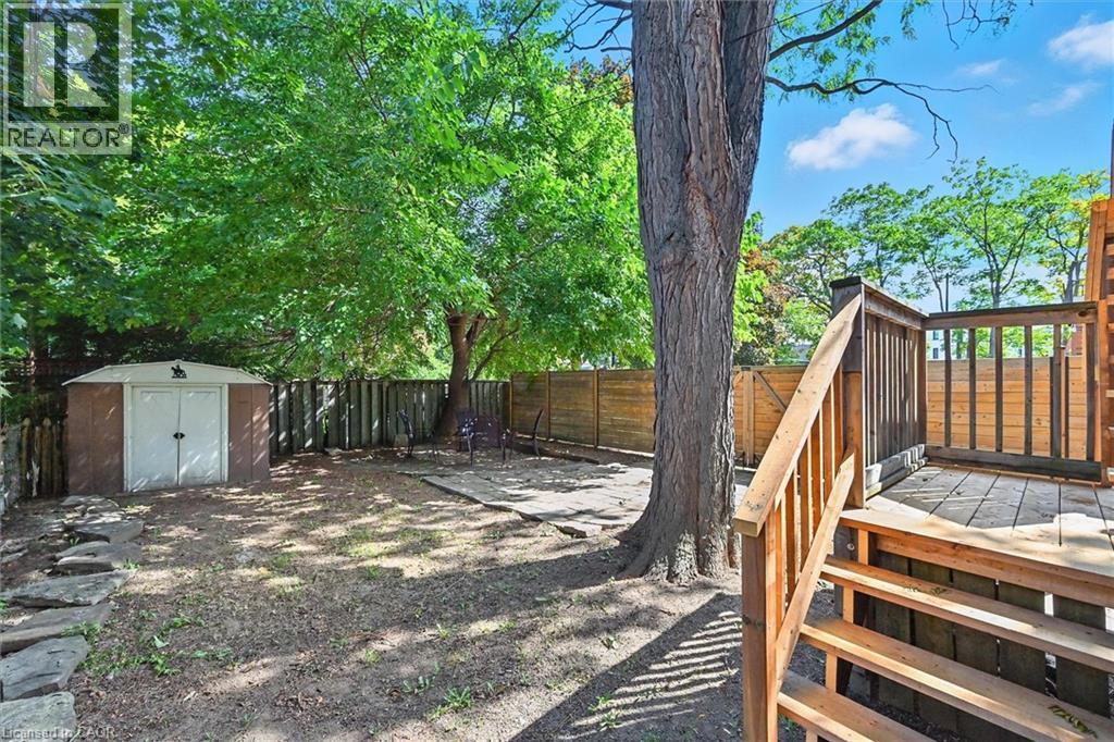 Fenced backyard with a storage unit - 1047 Main Street E, Hamilton, ON - Outdoor