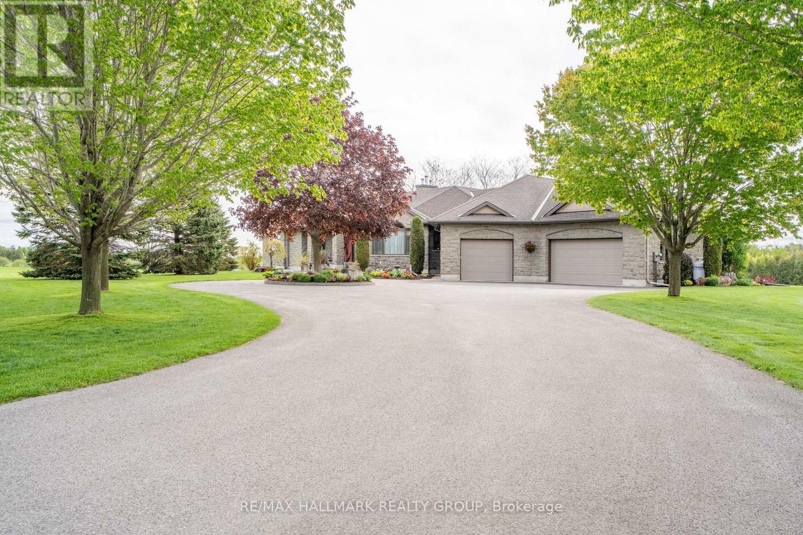 Wide Wrap Around Driveway with 3 Car Garage - 6980 Mansfield Road, Ottawa, ON - Outdoor