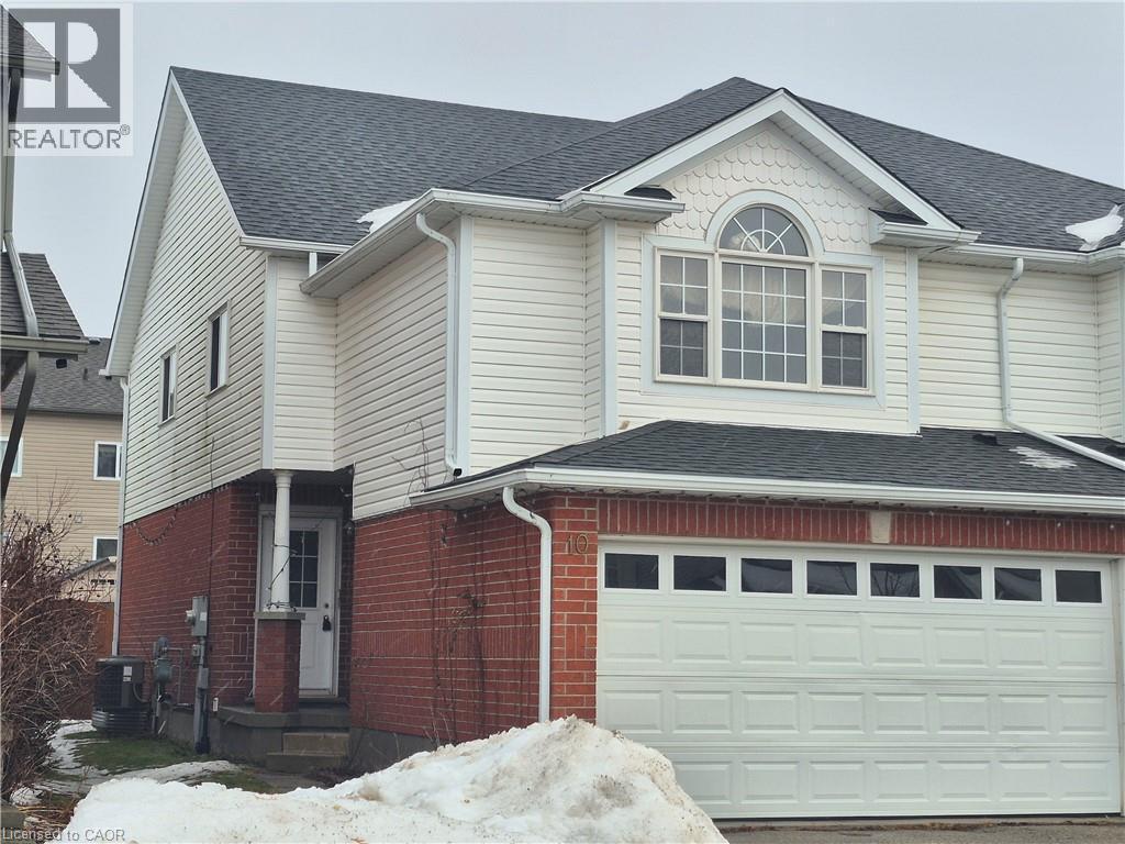 View of home's exterior with brick siding, a shingled roof, and a garage - 10 Donnenwerth Drive, Kitchener, ON - Outdoor With Exterior