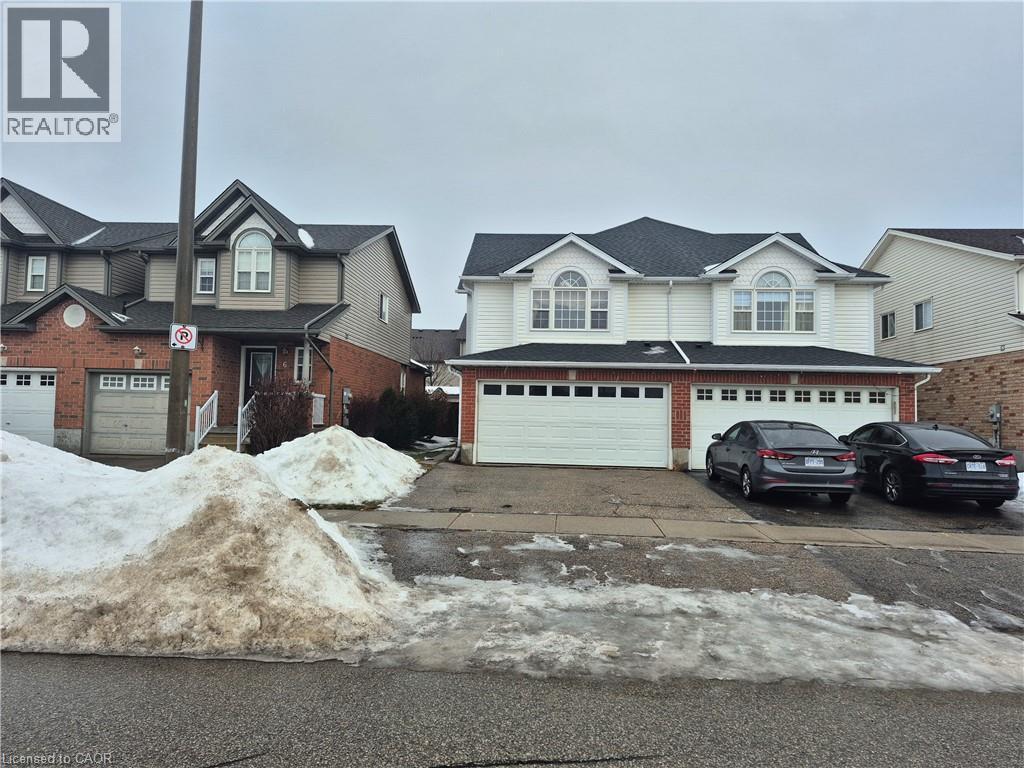 View of front of property with an attached garage, driveway, and roof with shingles - 10 Donnenwerth Drive, Kitchener, ON - Outdoor With Facade