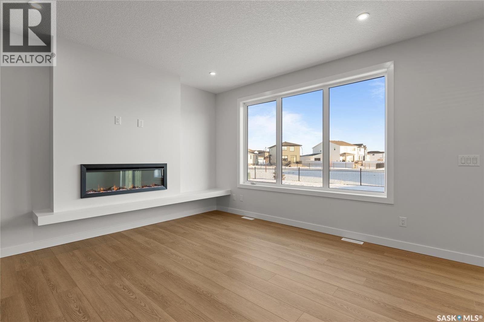 938 Brighton Gate, Saskatoon, SK - Indoor Photo Showing Living Room With Fireplace