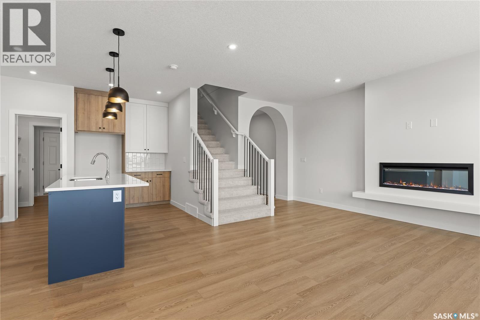 938 Brighton Gate, Saskatoon, SK - Indoor Photo Showing Other Room With Fireplace