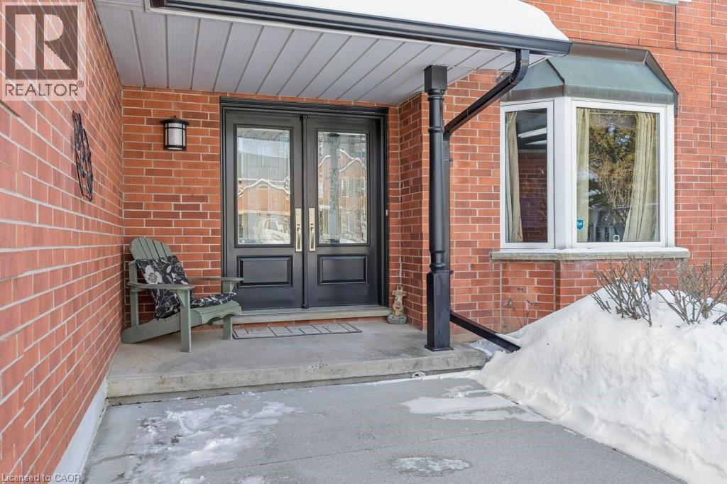 View of exterior entry with french doors, brick siding, and a porch - 148 Cowan Boulevard, Cambridge, ON - Outdoor With Deck Patio Veranda With Exterior