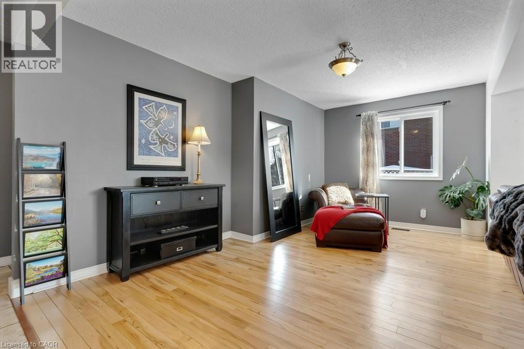 Living area featuring light wood-style floors and a textured ceiling - 148 Cowan Boulevard, Cambridge, ON - Indoor Photo Showing Living Room