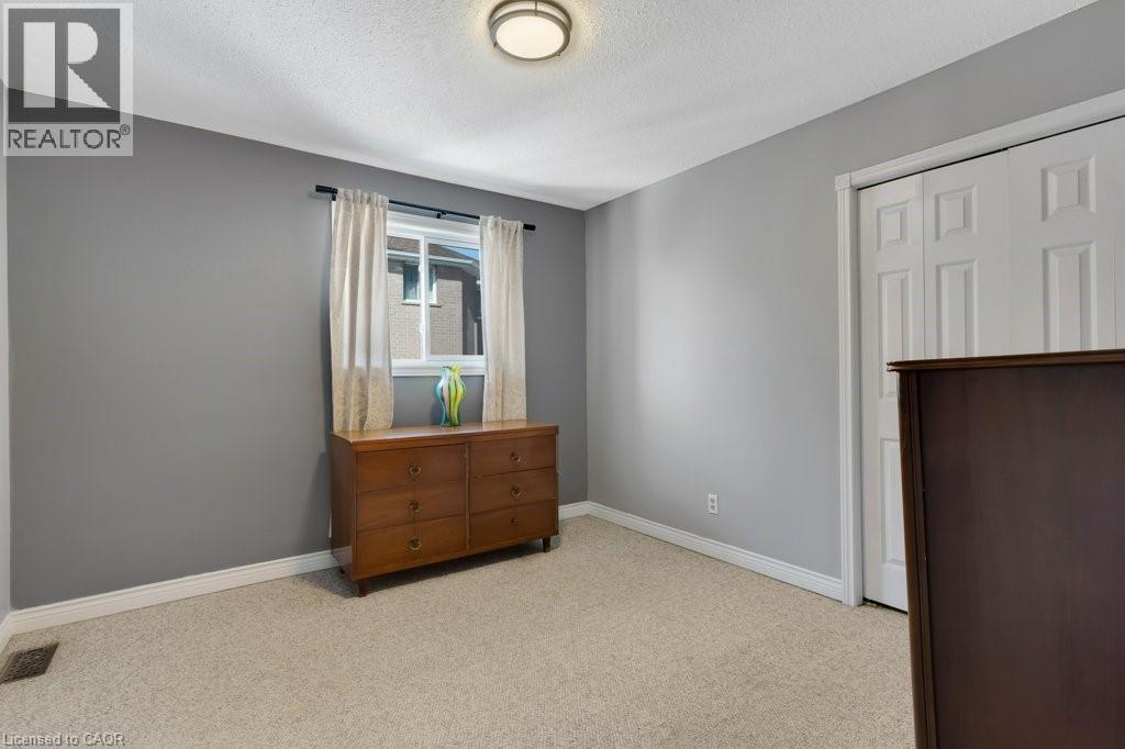 Bedroom with light colored carpet and a textured ceiling - 148 Cowan Boulevard, Cambridge, ON - Indoor