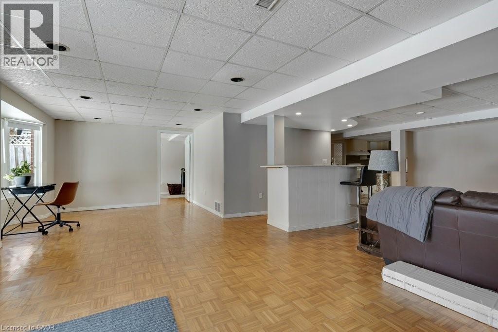 Living room with a paneled ceiling and parquet flooring - 148 Cowan Boulevard, Cambridge, ON - Indoor