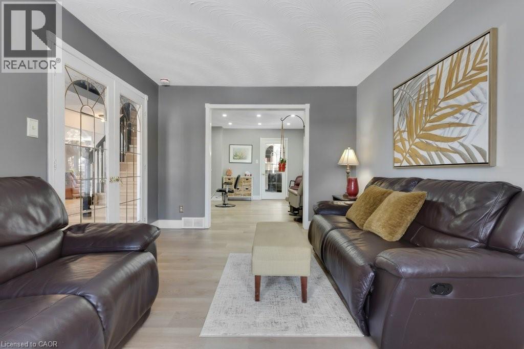 Living area with light wood-type flooring and french doors - 148 Cowan Boulevard, Cambridge, ON - Indoor Photo Showing Living Room