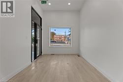 Empty room featuring light wood-type flooring and recessed lighting -