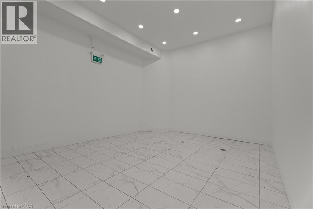 Empty room with recessed lighting - 93 John Street S, Hamilton, ON