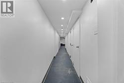 Hallway with finished concrete floors and recessed lighting -