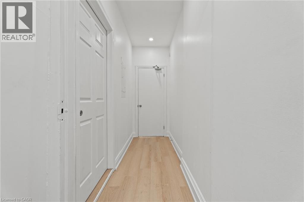 Hall with light wood-type flooring and recessed lighting - 93 John Street S, Hamilton, ON