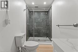 Full bath featuring a stall shower, light wood-type flooring, and recessed lighting -