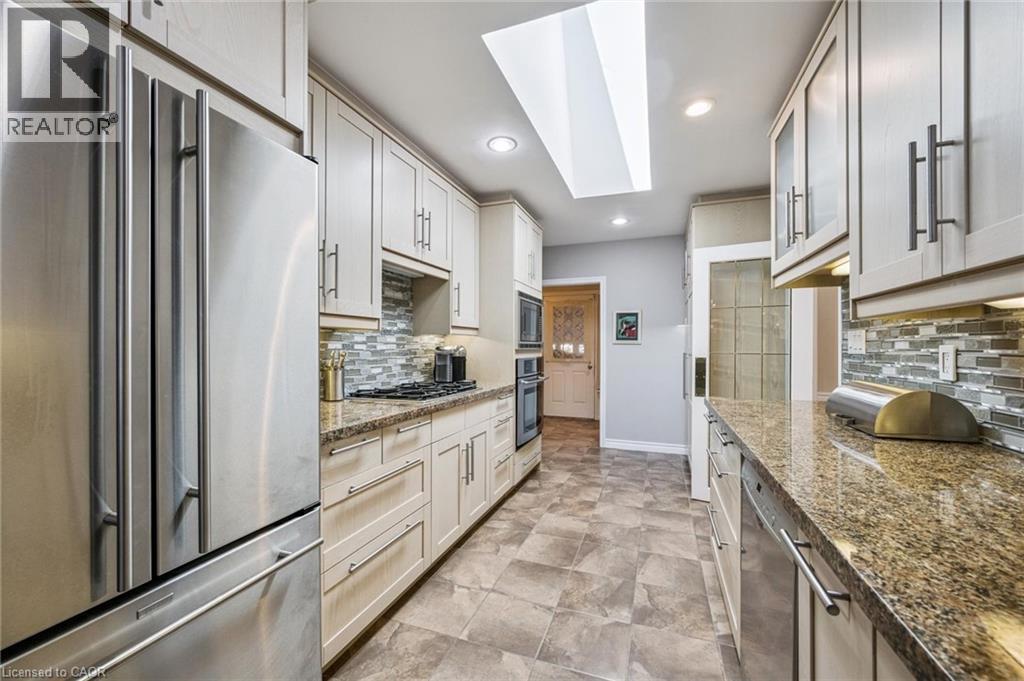 Mudroom in background, with door to garage. Miele dishwasher - 3012 First Street, Burlington, ON - Indoor Photo Showing Kitchen With Upgraded Kitchen
