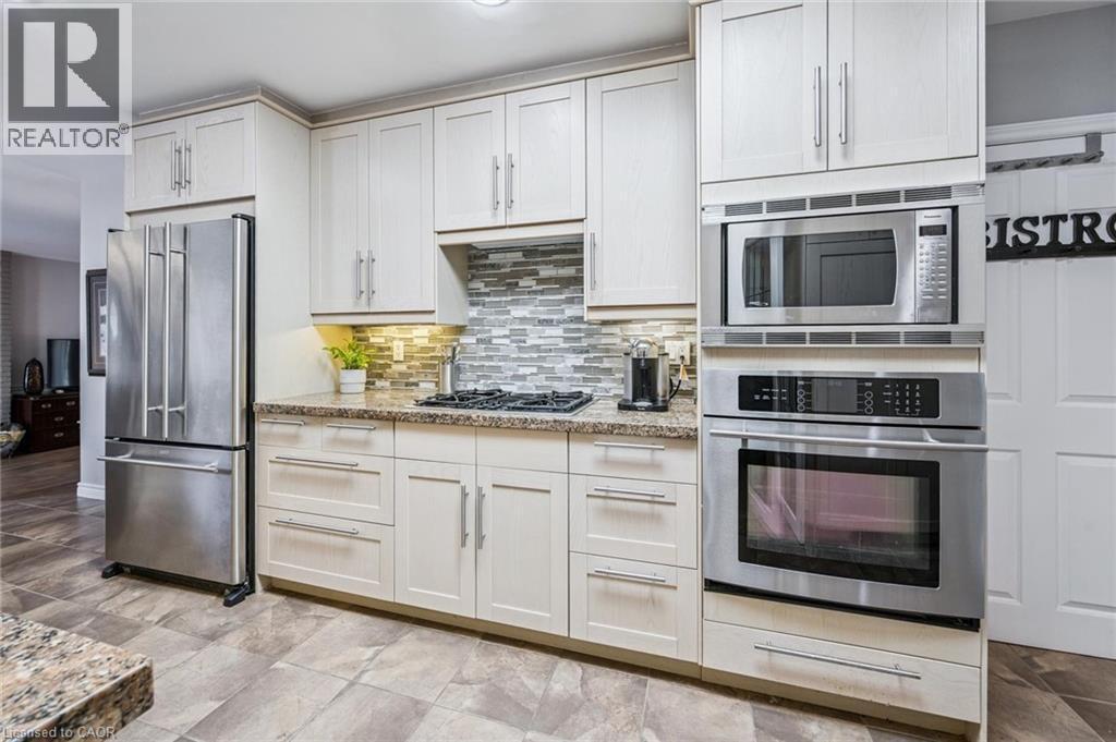 JennAire wall oven. Built in Panasonic microwave. Adjoining mudroom with entrance to garage. - 3012 First Street, Burlington, ON - Indoor Photo Showing Kitchen