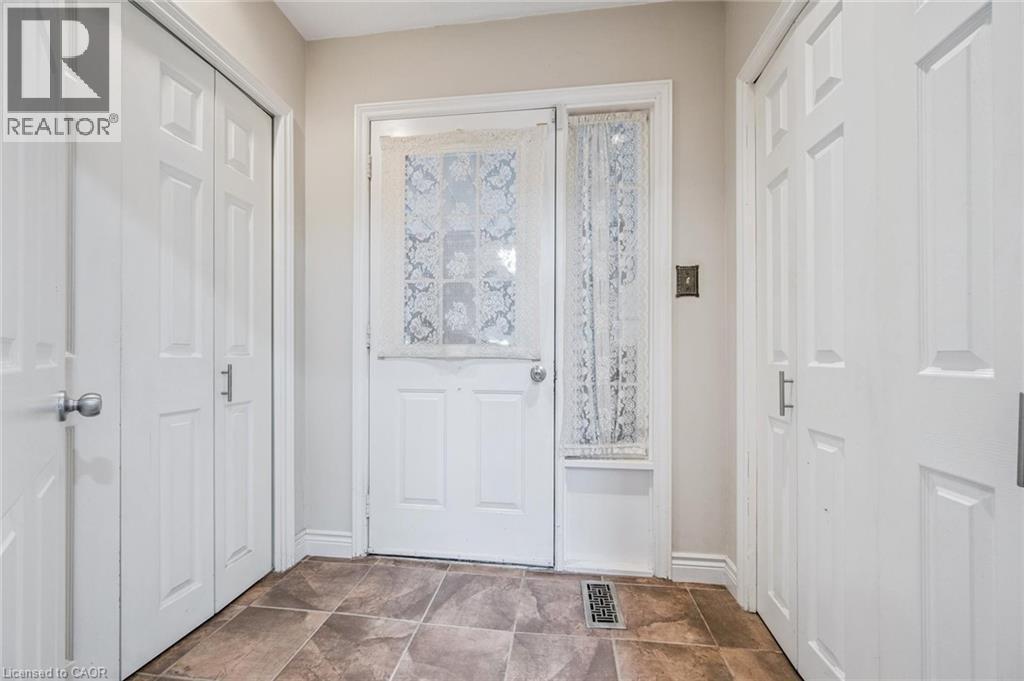 closet on left housed original laundry appliances. Door to garage. 2 closets - 3012 First Street, Burlington, ON - Indoor Photo Showing Other Room
