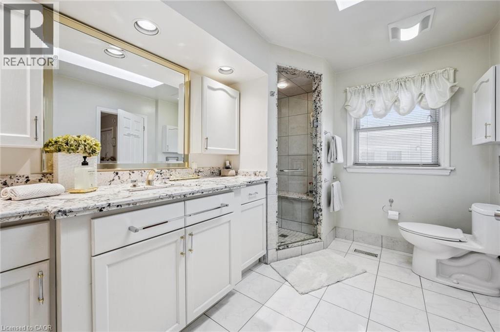 Separate shower and tub. High vanity. Skylight. - 3012 First Street, Burlington, ON - Indoor Photo Showing Bathroom