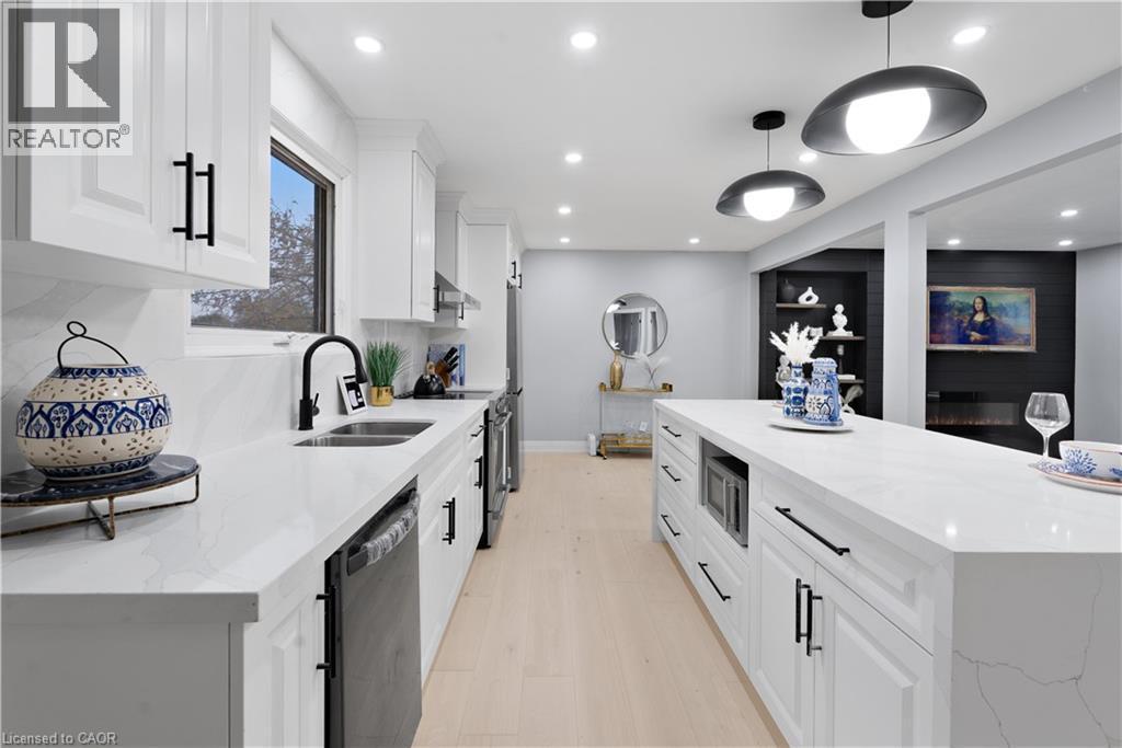 Kitchen with white cabinetry, light stone countertops, and recessed lighting - 19 Broad Street, Brantford, ON - Indoor Photo Showing Kitchen With Double Sink With Upgraded Kitchen