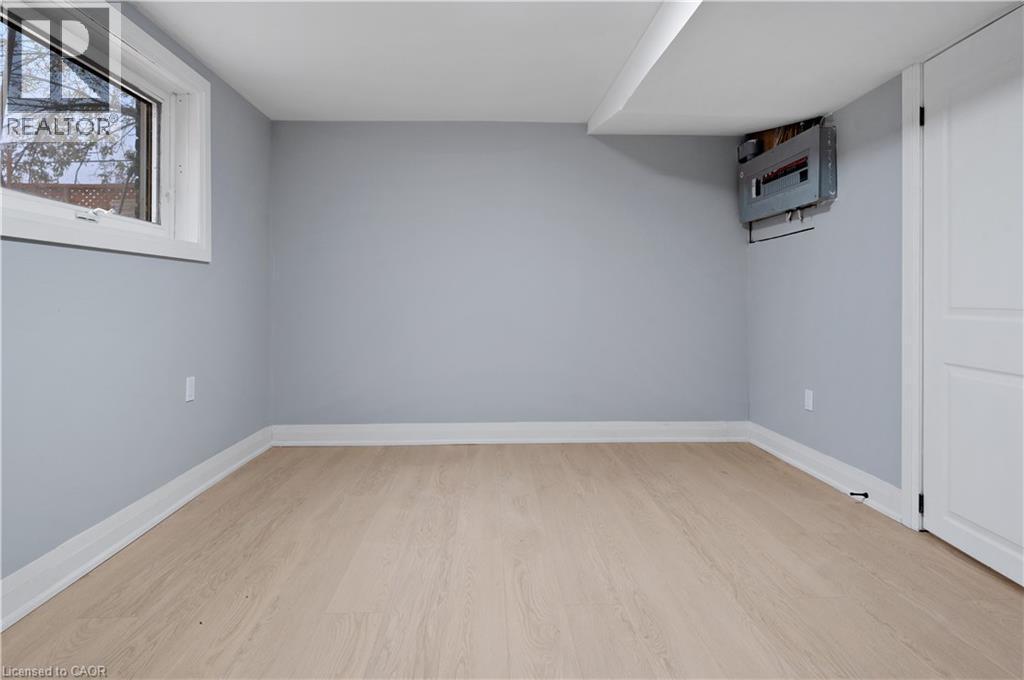 Below grade area featuring light wood-style flooring and baseboards - 19 Broad Street, Brantford, ON - Indoor Photo Showing Other Room