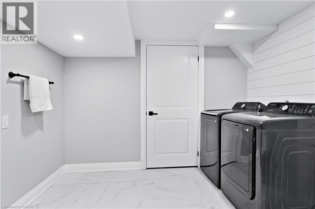 Washroom featuring light marble finish flooring, separate washer and dryer, and recessed lighting - 19 Broad Street, Brantford, ON - Indoor Photo Showing Laundry Room
