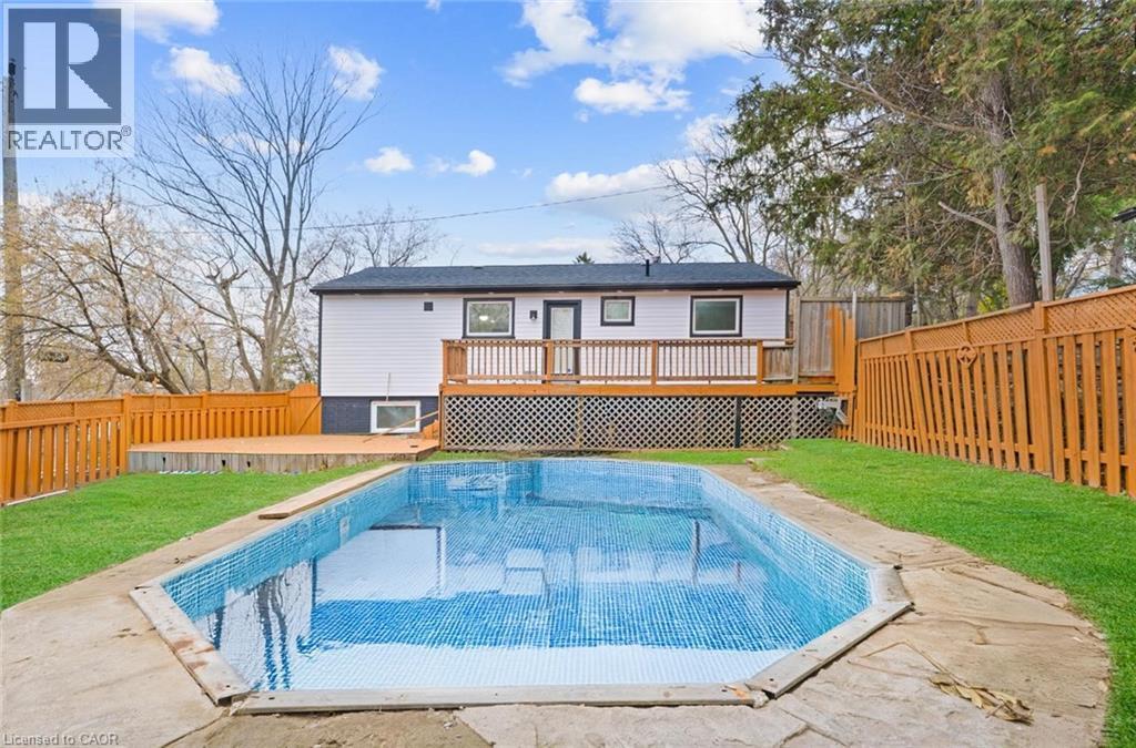 Back of house with a fenced backyard, a deck, and a patio - 19 Broad Street, Brantford, ON - Outdoor With Deck Patio Veranda