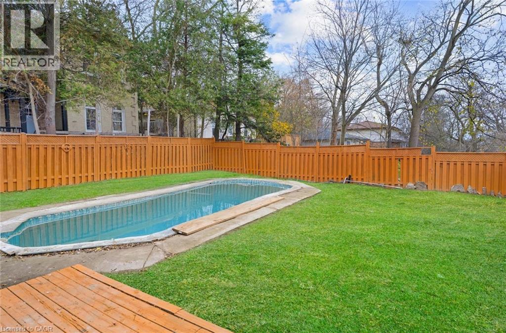 View of swimming pool featuring a fenced backyard - 19 Broad Street, Brantford, ON - Outdoor With In Ground Pool With Deck Patio Veranda With Backyard