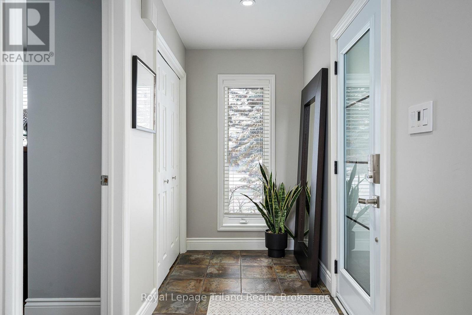 Light-filled, open foyer with tile floors & closet - 19 Trails End, Collingwood, ON
