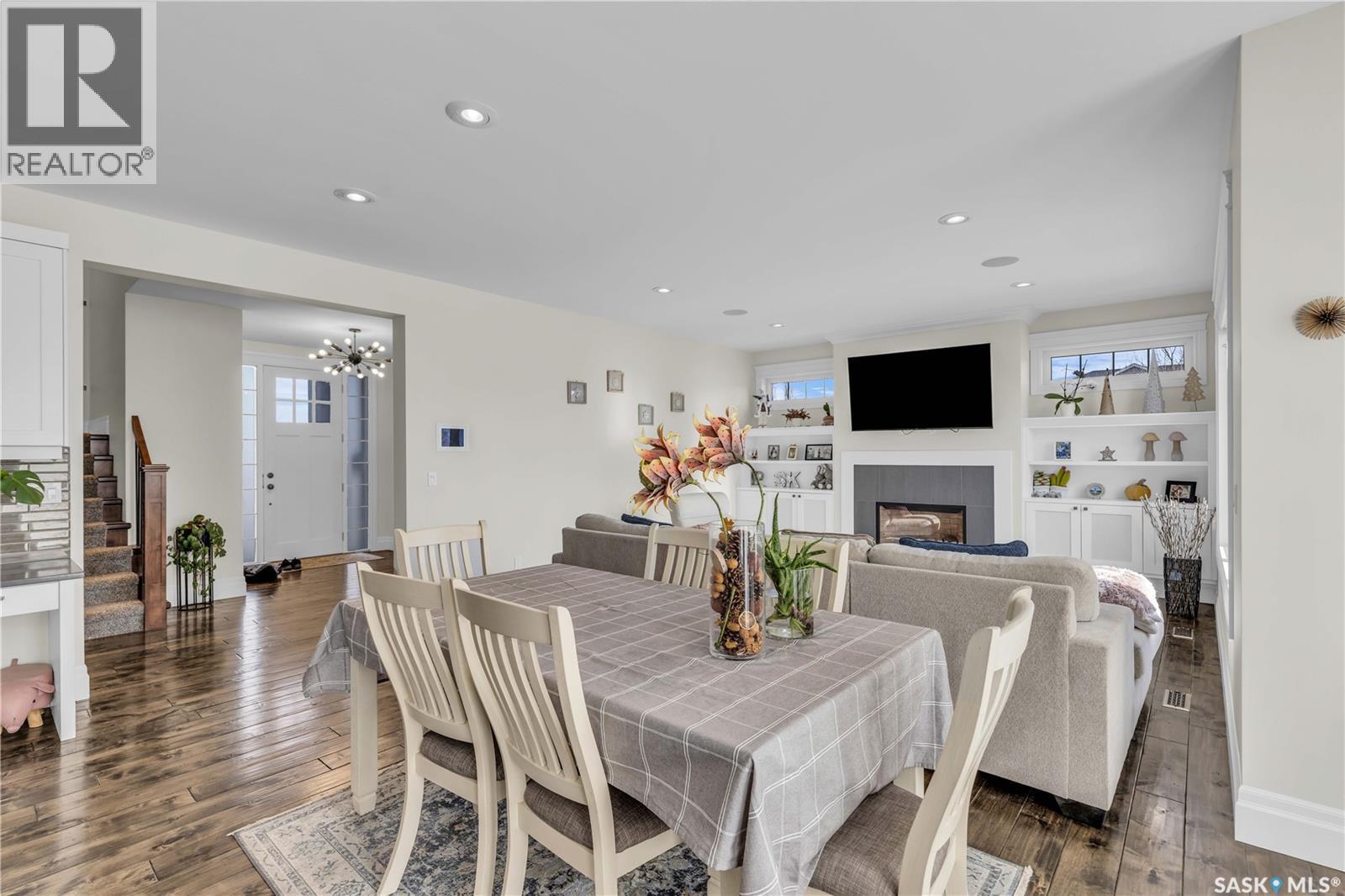 438 Horlick Manor, Saskatoon, SK - Indoor Photo Showing Dining Room With Fireplace