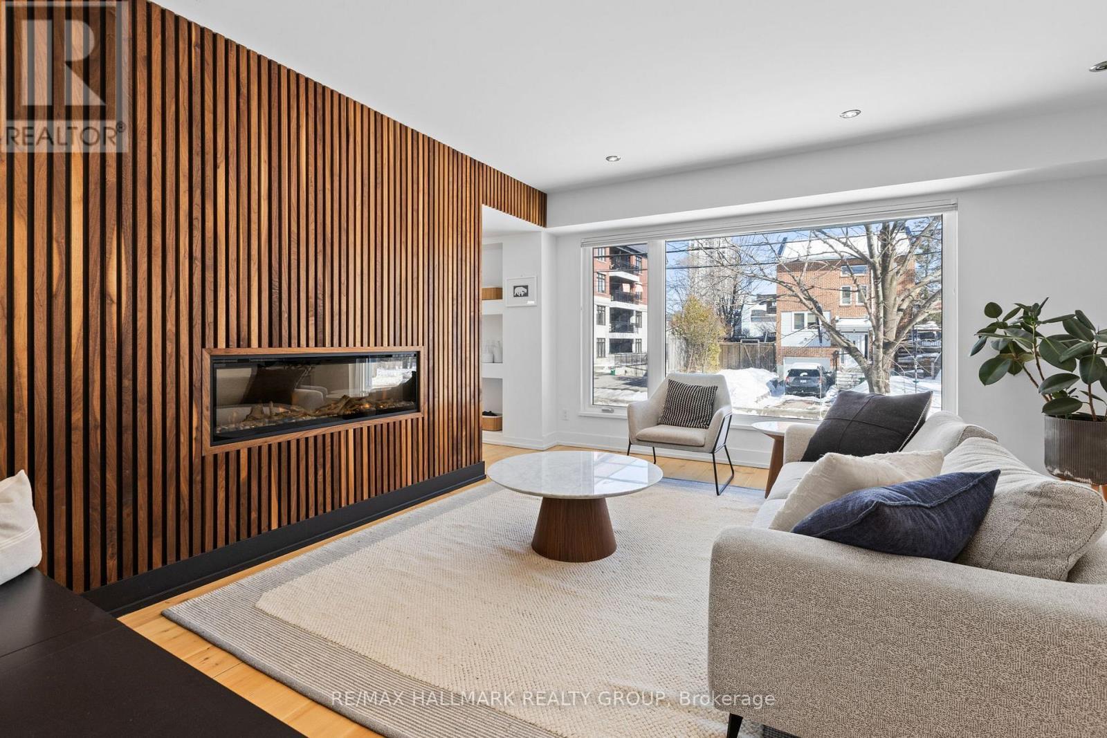 Living room with wood feature wall - 330 Winona Avenue, Ottawa, ON - Indoor Photo Showing Living Room With Fireplace