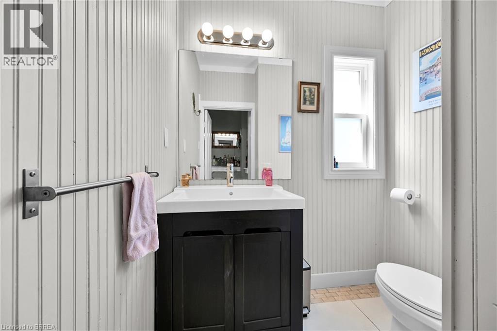 Bathroom featuring toilet, vanity, and tile patterned flooring - 40 Locke Street S, Hamilton, ON - Indoor Photo Showing Bathroom