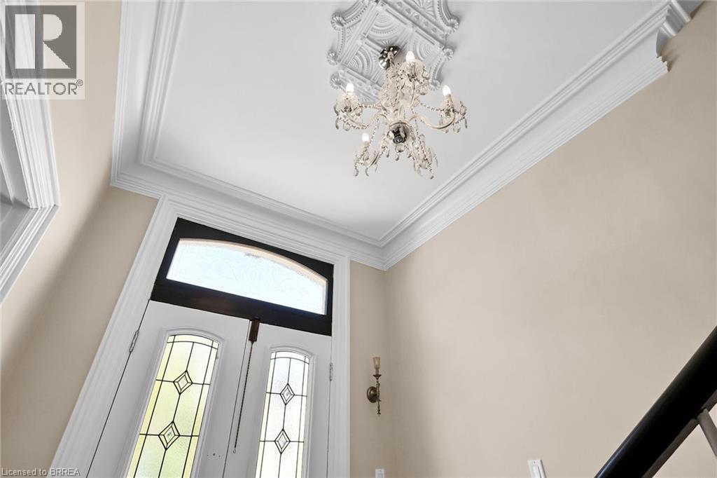 Foyer featuring french doors, a chandelier, and ornamental molding - 40 Locke Street S, Hamilton, ON - Indoor Photo Showing Other Room