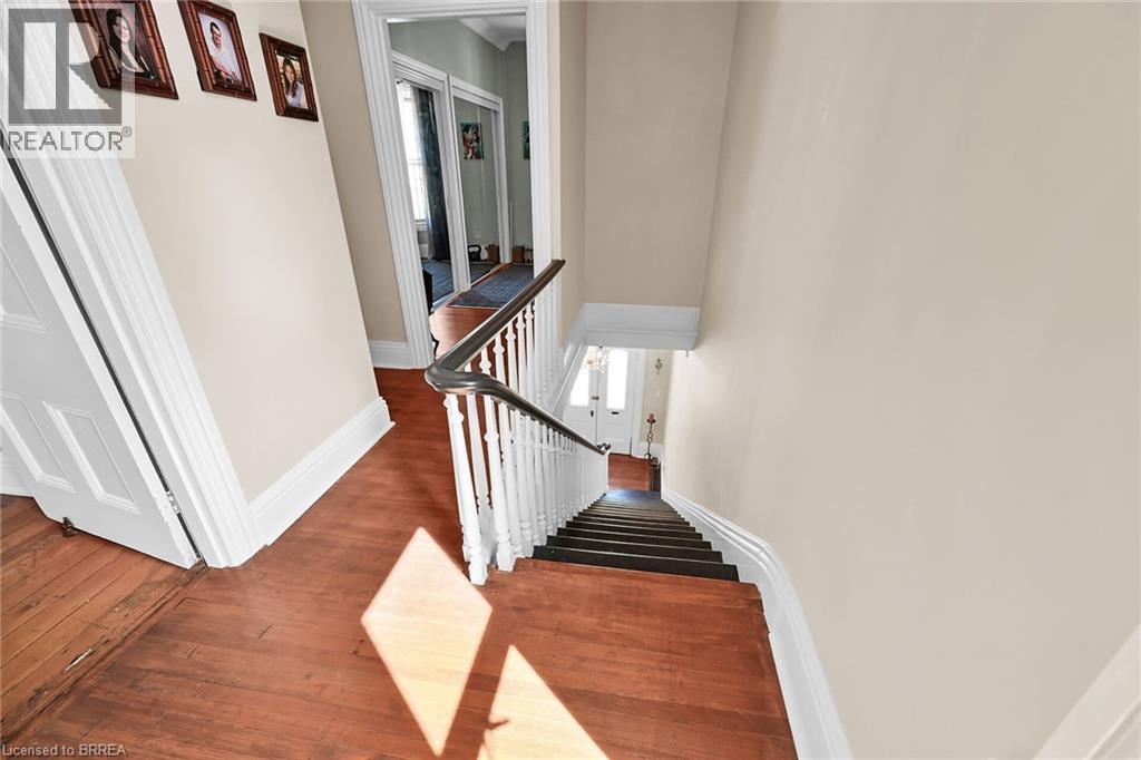 Stairs featuring wood-type flooring - 40 Locke Street S, Hamilton, ON - Indoor Photo Showing Other Room